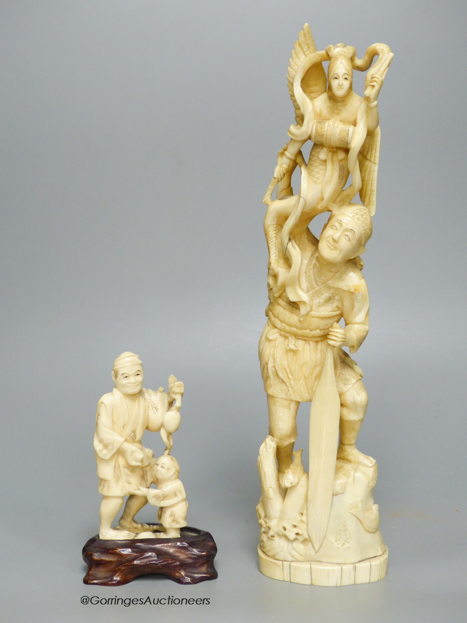 Two early 20th century Japanese walrus ivory okimono, tallest 29cm